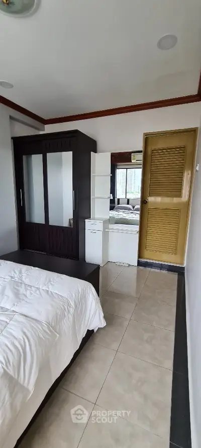 Spacious bedroom with modern wardrobe and natural light