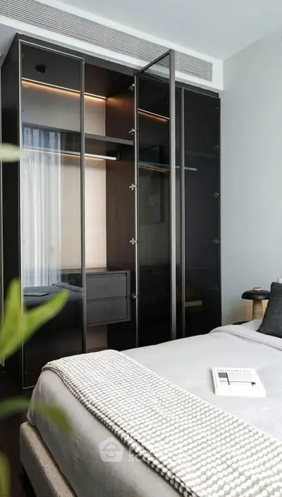 Modern bedroom with sleek glass wardrobe and cozy bedding