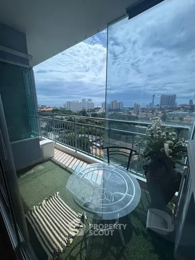 Stunning balcony view with cityscape and cozy outdoor seating area.