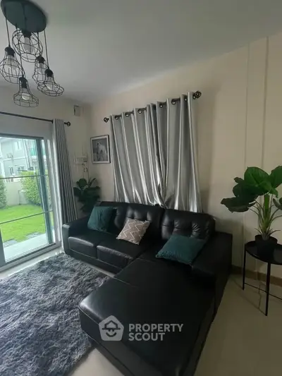 Stylish living room with modern leather sofa and garden view