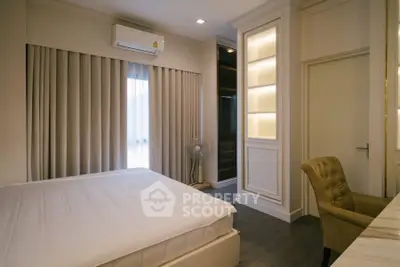 Elegant bedroom with modern design, featuring built-in shelves and cozy lighting.