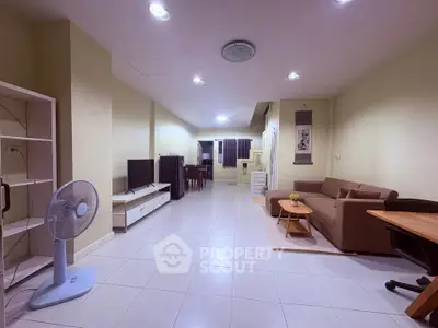 Spacious living room with modern furniture and open layout, perfect for family gatherings.