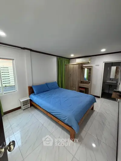 Spacious bedroom with modern furnishings and natural light