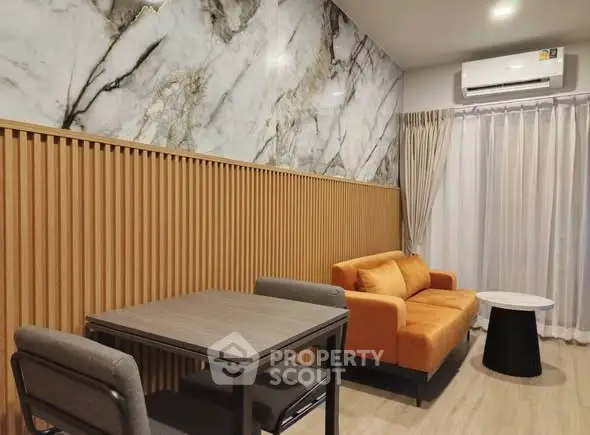 Modern living room with marble accent wall and stylish furniture