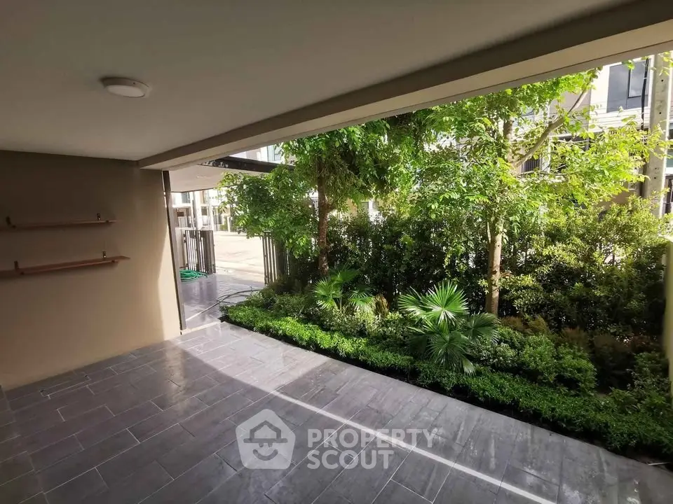 Spacious covered patio with lush garden view in modern property