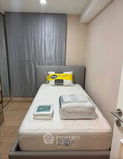 Cozy bedroom with a single bed and modern decor, perfect for a comfortable living space.