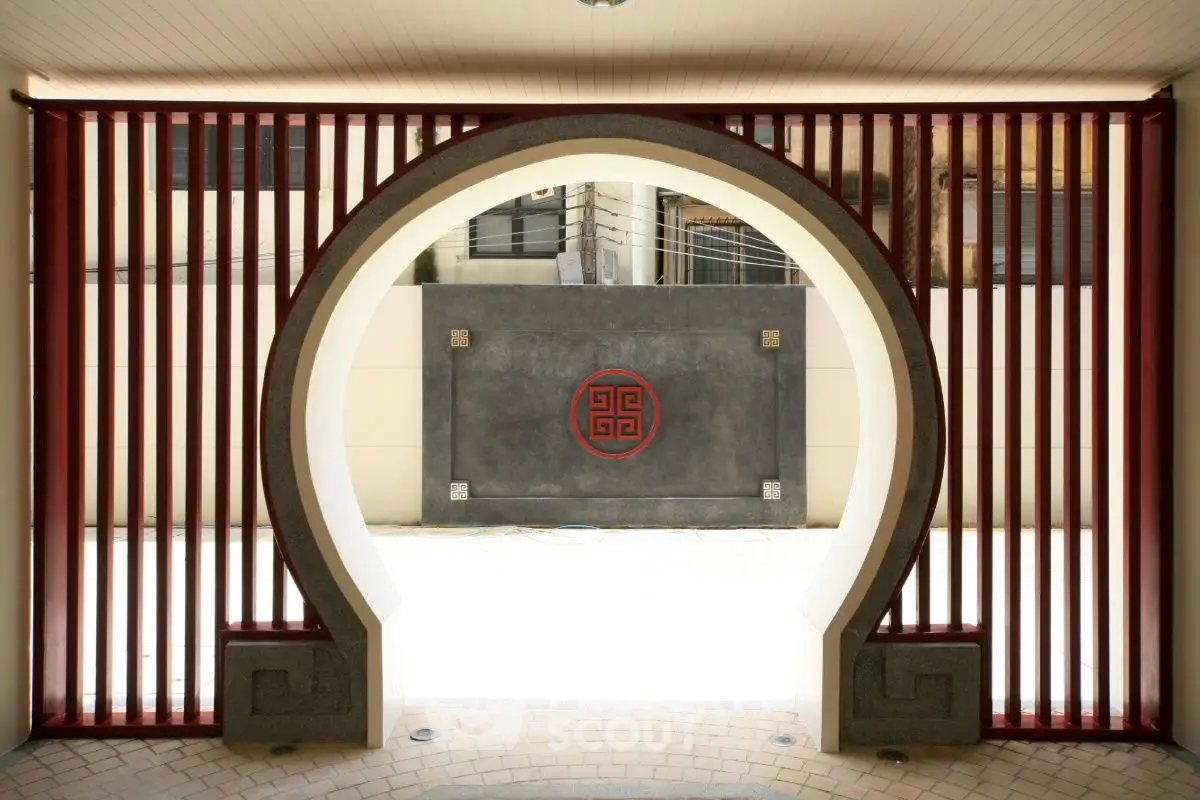 Elegant entrance with unique circular design and traditional Asian architectural elements.