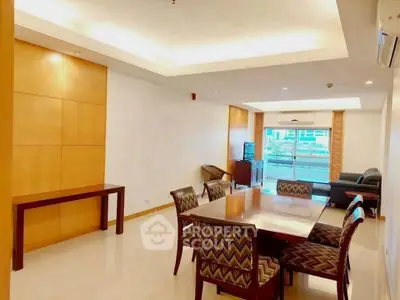 Spacious modern living room with elegant dining area and balcony view