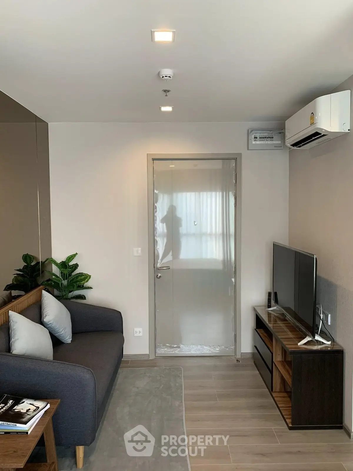 Modern living room with sleek furniture and air conditioning, perfect for cozy relaxation.