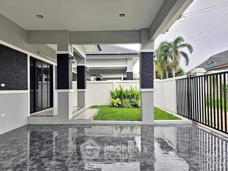Modern home exterior with sleek patio and lush garden, perfect for outdoor relaxation.