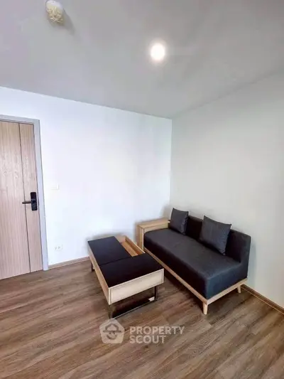 Modern minimalist living room with sleek furniture and wooden flooring