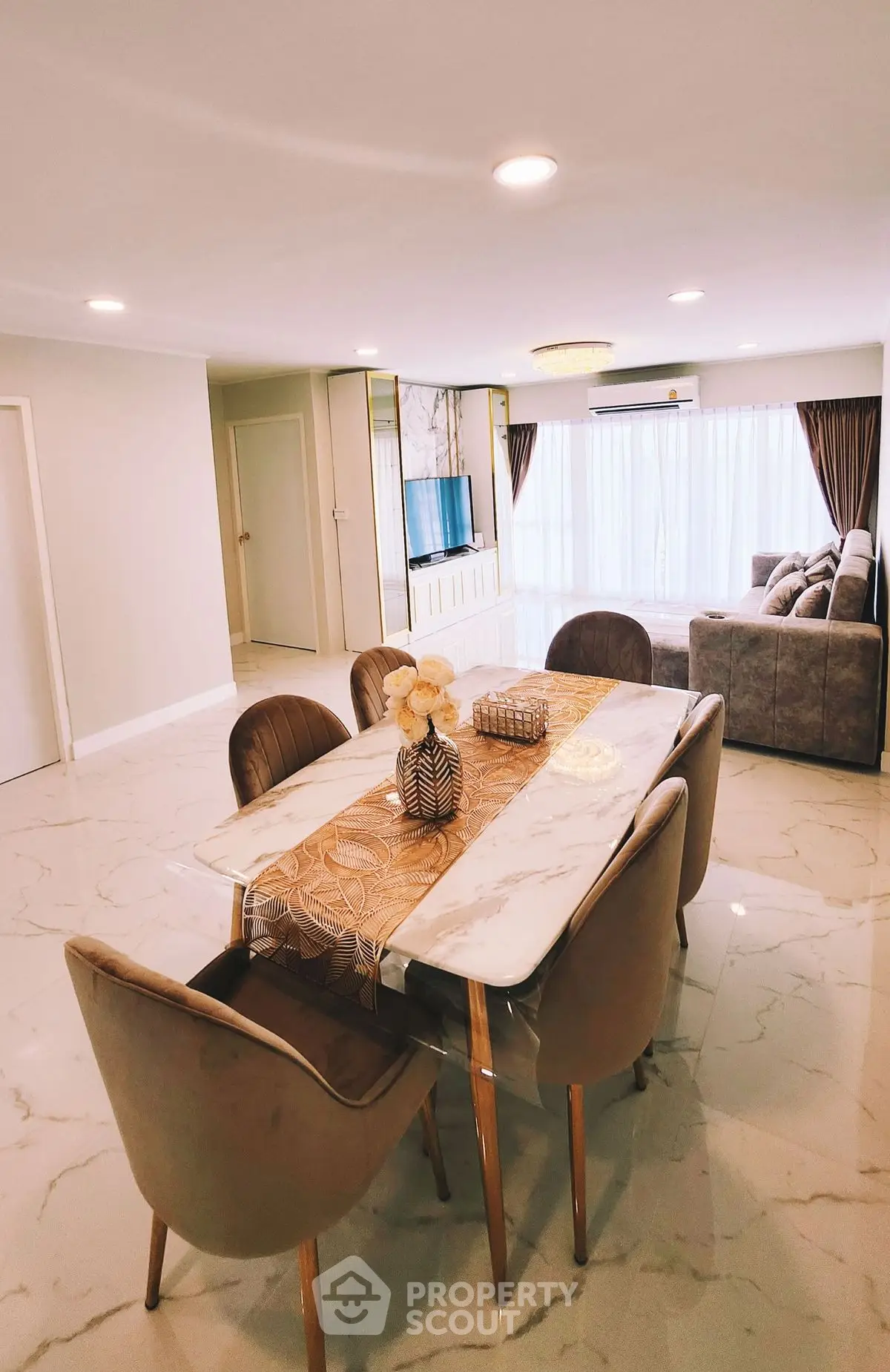 Spacious modern living room with elegant dining area and luxurious marble flooring.