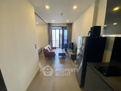 Modern living room with sleek furniture and balcony view in a stylish apartment.