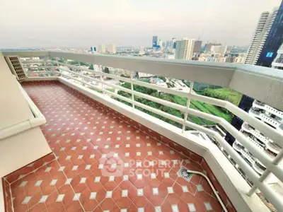 Spacious balcony with stunning city view and tiled flooring in high-rise building.