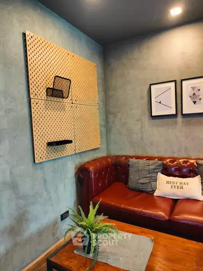 Stylish living room with leather sofa and modern wall art