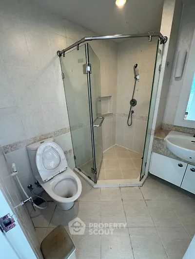 Modern bathroom with glass shower enclosure and sleek fixtures