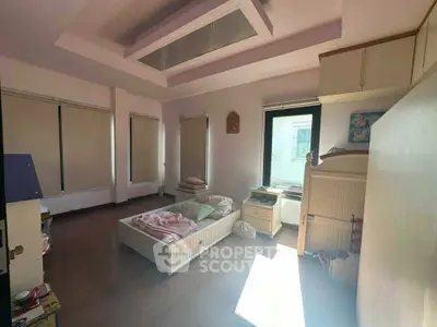 Spacious bedroom with natural light and modern decor