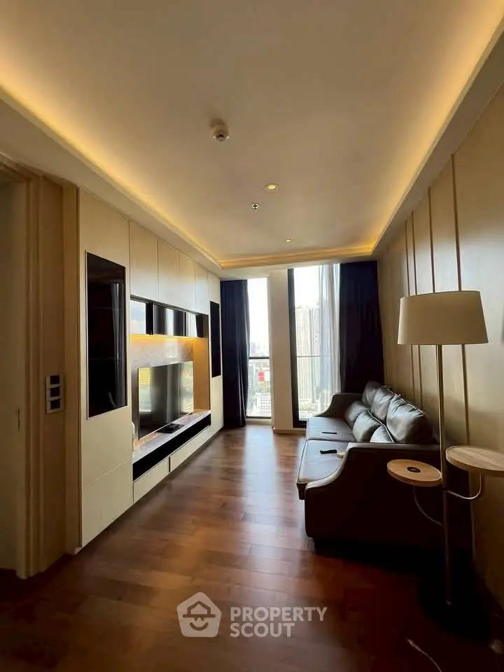 Luxurious living room with modern design and city view, featuring sleek furniture and ambient lighting.