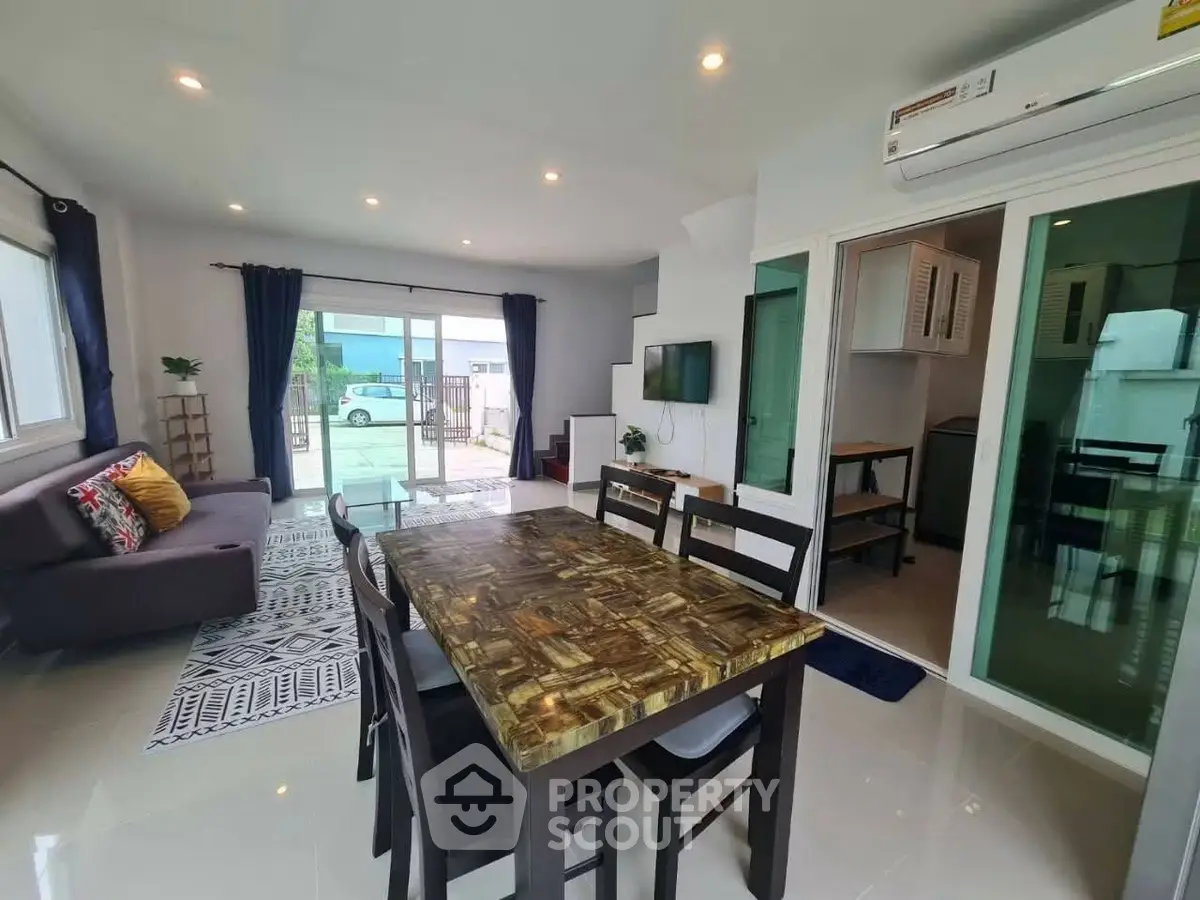 Spacious modern living room with dining area and stylish decor in a bright open layout.