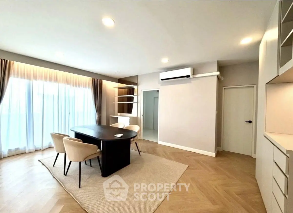 Spacious modern living room with elegant dining area and natural light