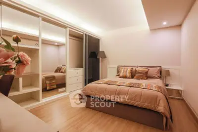 Elegant bedroom with modern decor and ample closet space in a cozy apartment.