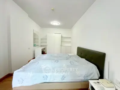 Spacious bedroom with modern decor and ample storage in a stylish apartment.