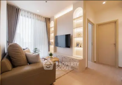 Modern living room with elegant decor and natural light, featuring a cozy sofa and wall-mounted TV.