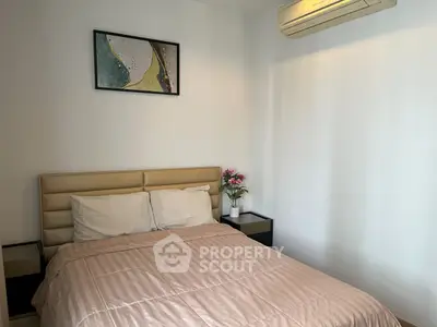 Cozy bedroom with modern decor and air conditioning, perfect for relaxation.