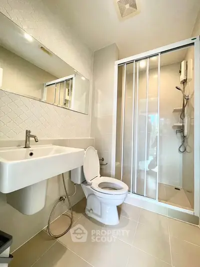 Modern bathroom with sleek shower and elegant fixtures in a contemporary apartment.