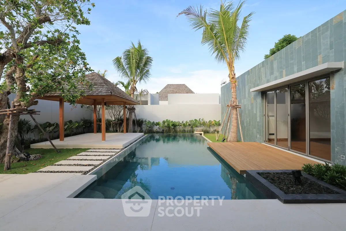Luxurious modern villa with private pool and tropical garden oasis.