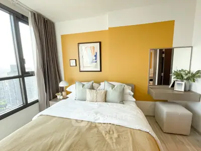 Modern bedroom with large window and stylish decor in urban apartment