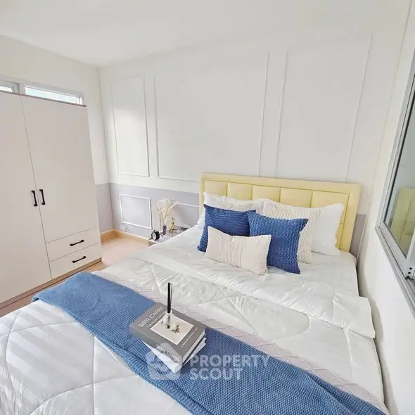 Bright and cozy bedroom with stylish decor and ample natural light