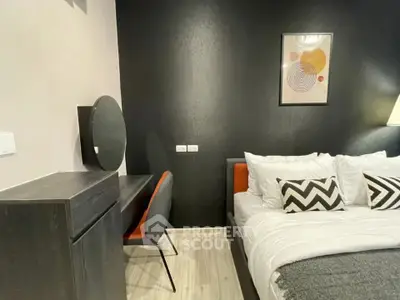 Modern bedroom with stylish decor and cozy bedding in a contemporary apartment.