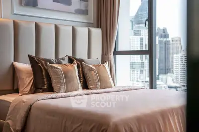 Luxurious bedroom with plush bedding and city view in modern high-rise apartment.