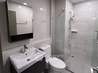 Modern bathroom with sleek fixtures and glass shower enclosure