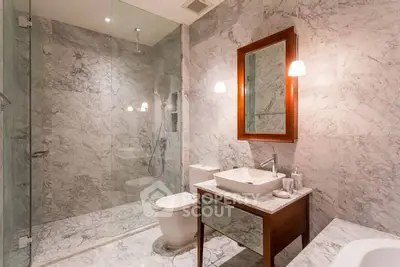 Luxurious marble bathroom with modern fixtures and elegant lighting