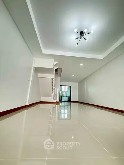 Spacious modern living room with glossy tiled floors and stylish lighting