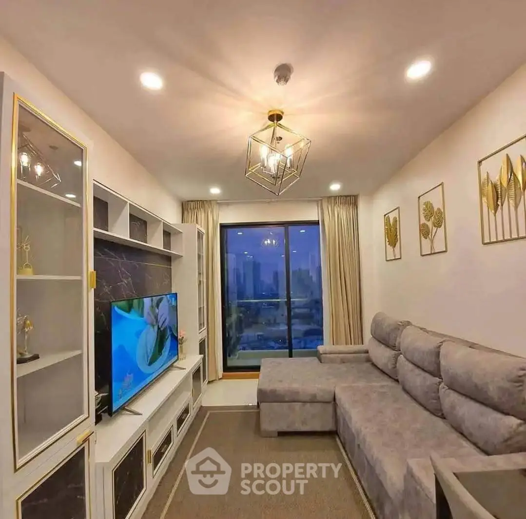 Luxurious living room with modern decor and stunning city view through large window.