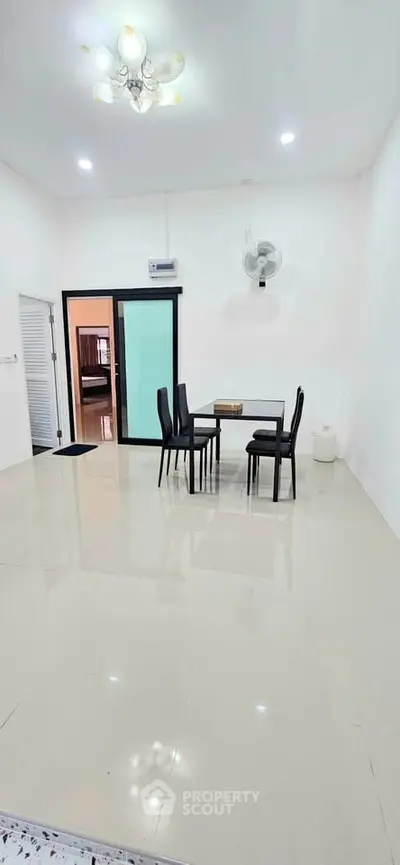 Spacious dining area with modern furniture and bright lighting in a contemporary home.