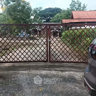 Charming rustic property with gated entrance and lush greenery, perfect for serene living.