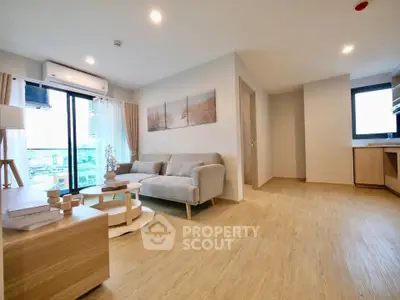 Spacious modern living room with wooden flooring and natural light