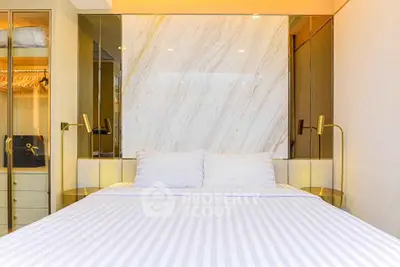 Luxurious bedroom with elegant marble accent wall and modern lighting fixtures.
