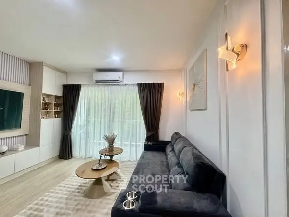 Modern living room with stylish decor and large window for natural light