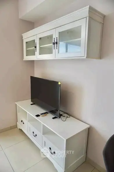 Modern living room with sleek white TV stand and wall-mounted cabinet