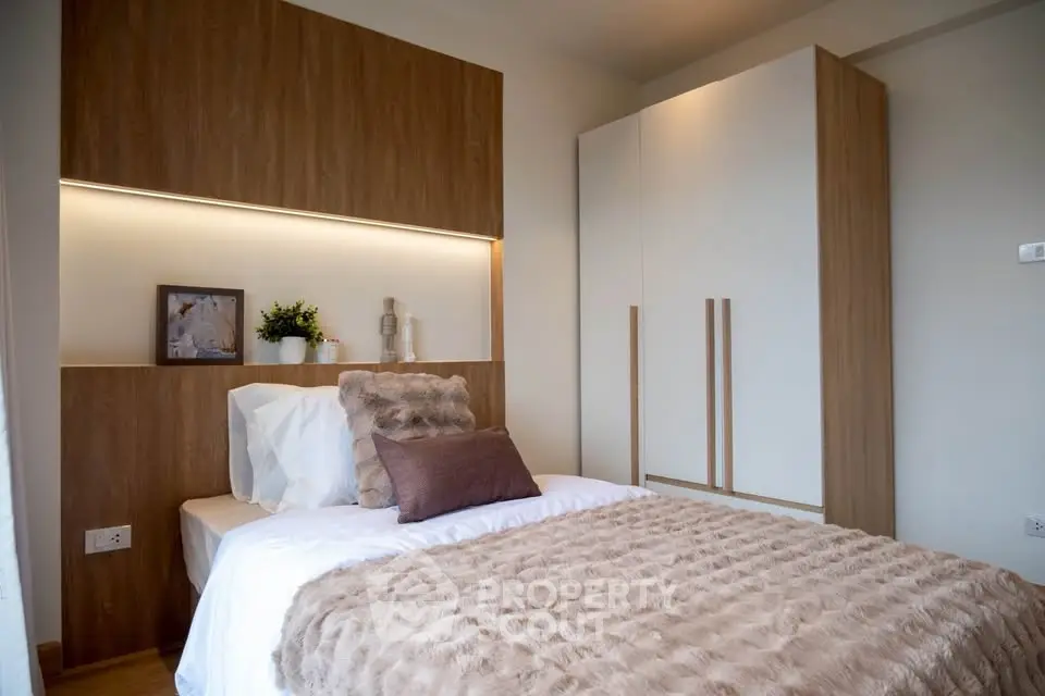 Cozy modern bedroom with stylish decor and ample storage space.