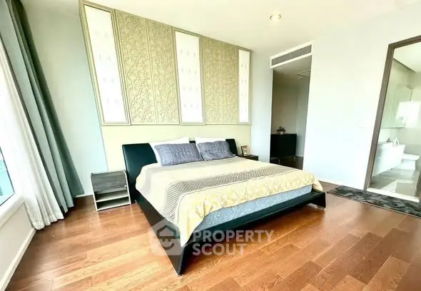 Spacious modern bedroom with elegant decor and hardwood floors