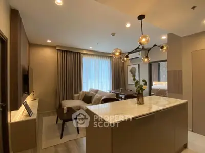 Modern open-layout living room with stylish lighting and cozy seating area