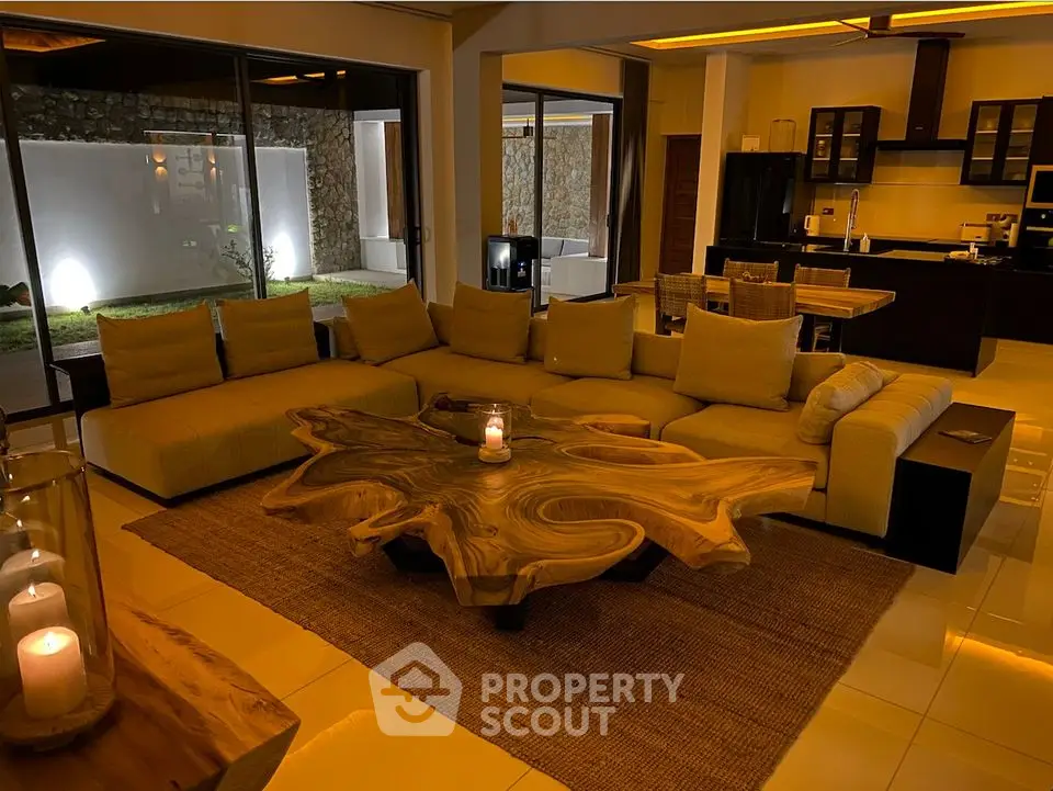Luxurious living room with modern decor and ambient lighting, featuring a unique wooden coffee table and spacious seating.