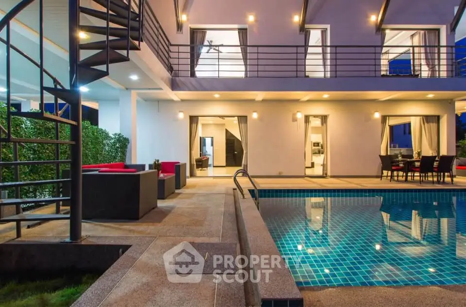 Luxurious modern villa with private pool and stylish outdoor seating area, perfect for entertaining.