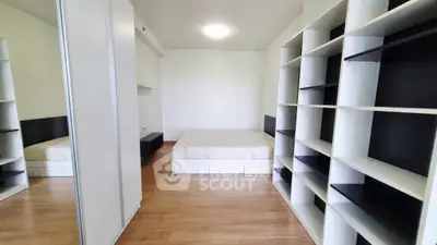 Spacious bedroom with modern shelving and minimalist design